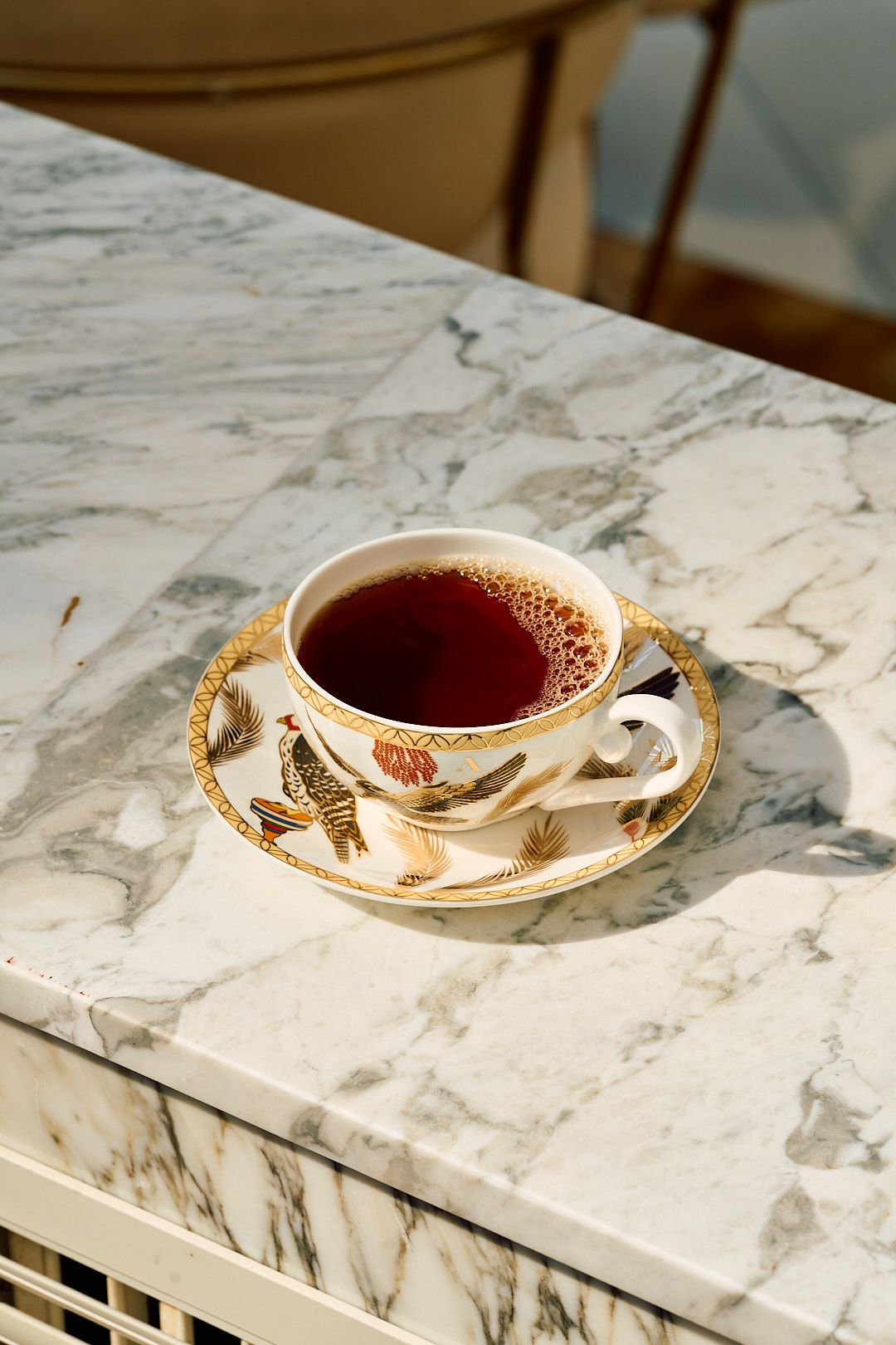 An Al-Bidaa porcelain cup at rest on veined marble